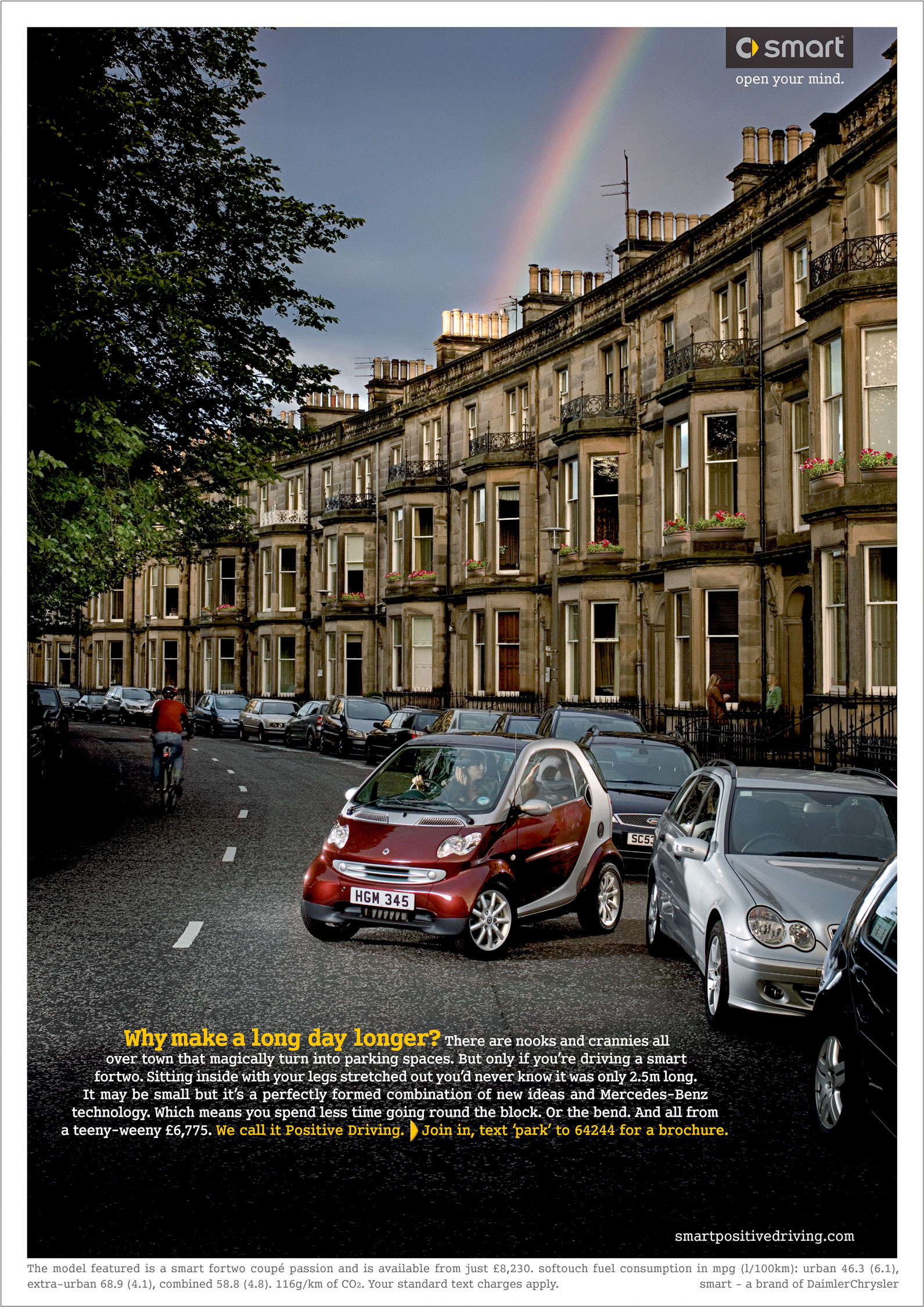 Red Smart car parking in traditional georgian cresent, edinburgh scotland with rainbow from chimney pots